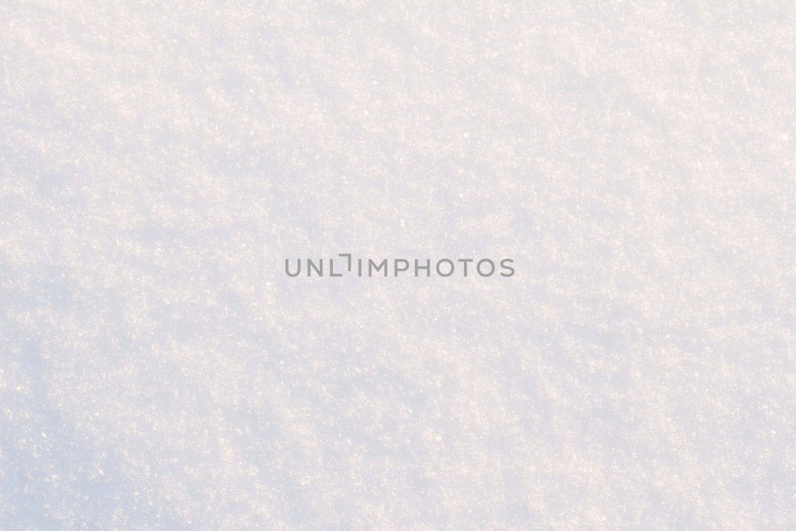 Snow texture close-up. White frost snow toned in blue background.