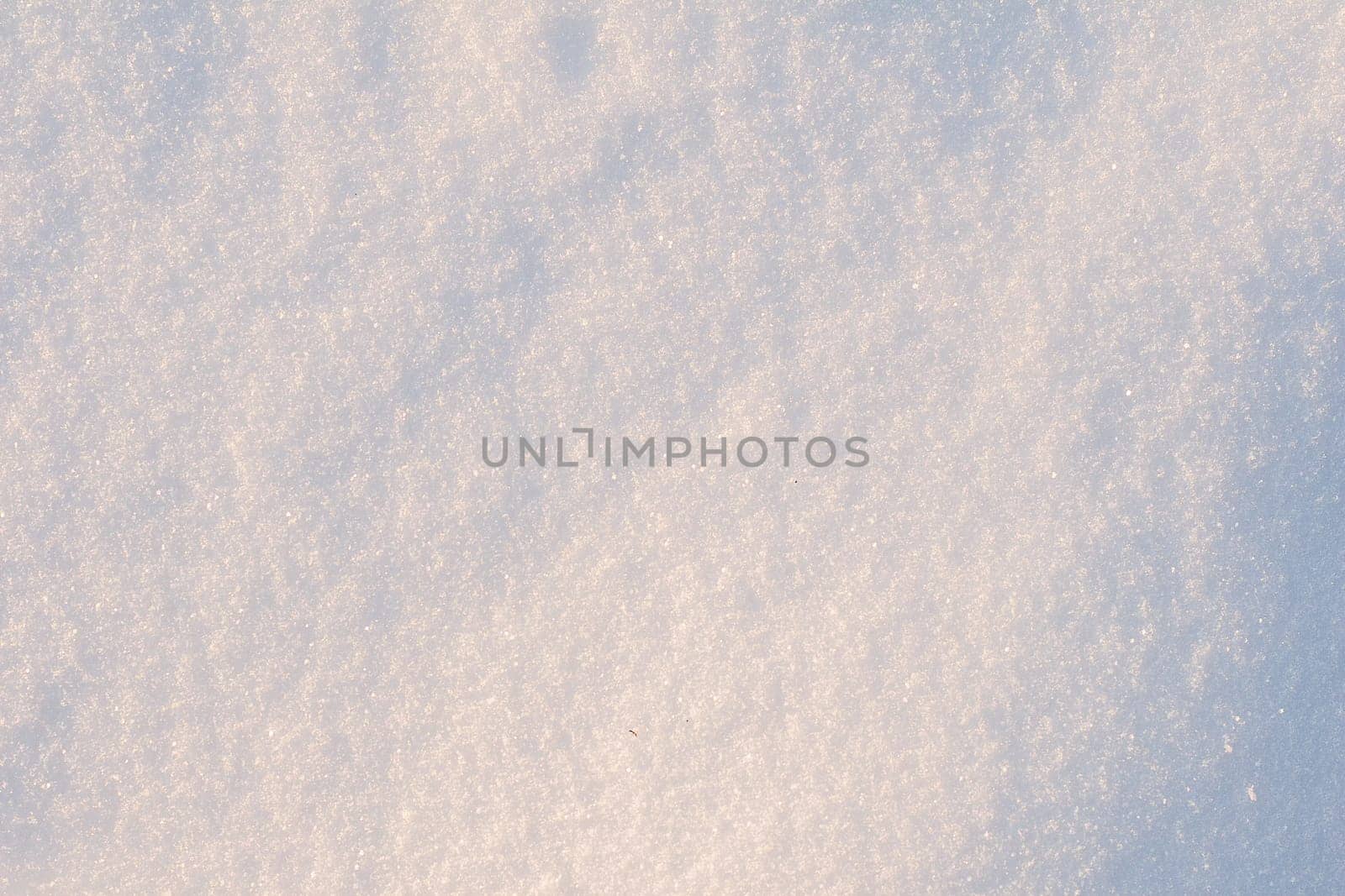 Front view of snow texture on the ground during the winter. Snow texture close-up.