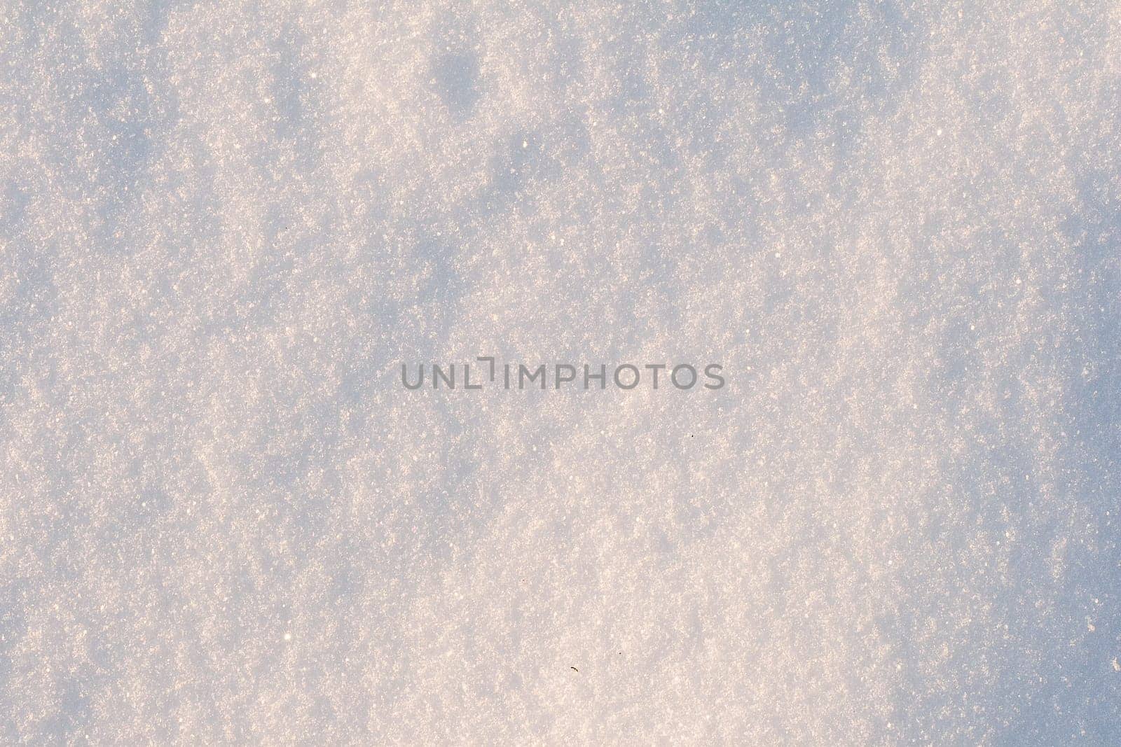 White frost snow toned in blue background. Snow texture close-up.