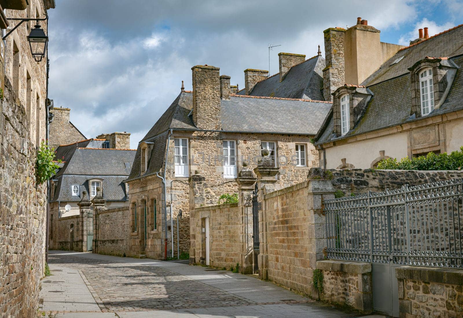 Dinan, medieval town center, Brittany, France. Dinan, traditional colorful houses on a cobbled street in medieval town center, Brittany, France