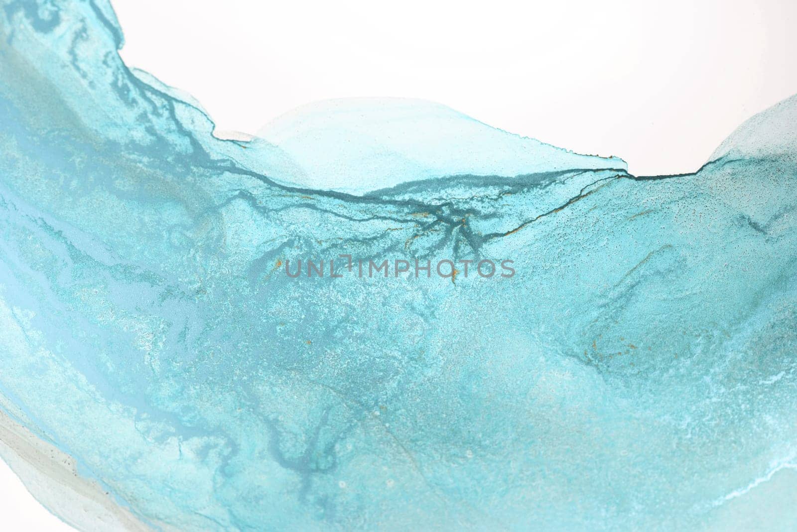 A close-up shot of a blue ink swirl on a white background, creating an abstract pattern.