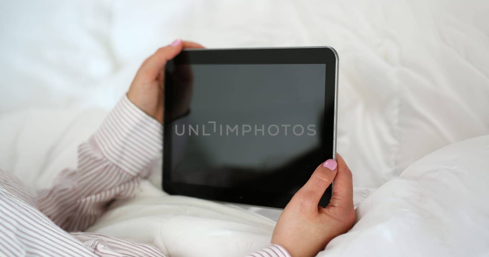 Close-up of woman holding tablet device with locked screen, turned off gadget. Tablet doesnt work, useless device. Mockup, technology concept. Copy space