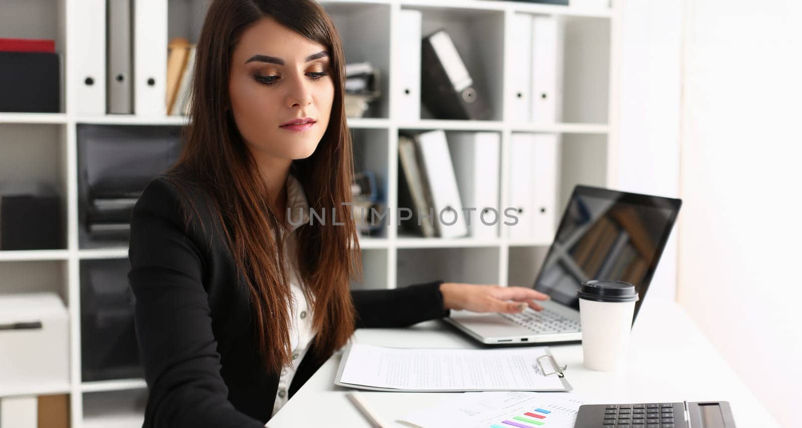 Portrait of woman secretary on workplace, busy with planning, laptop device on desk. First working day, fresh start. Clerk, secretary, office life concept