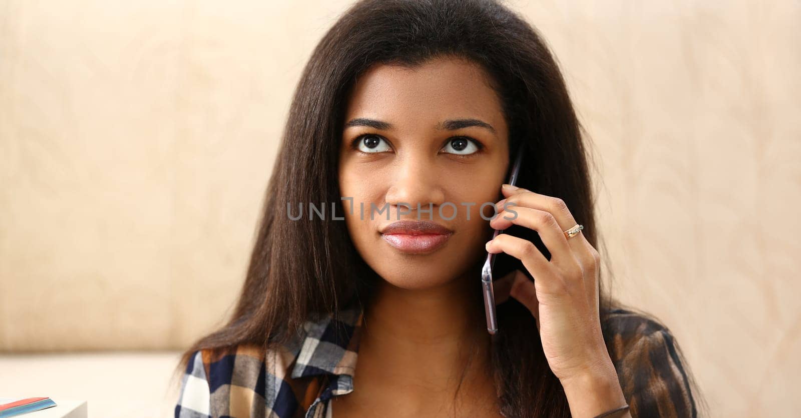 Portrait of beautiful latin woman chatting on mobile phone with friend, afro american female look away. Discuss news, happy to hear. Communication concept