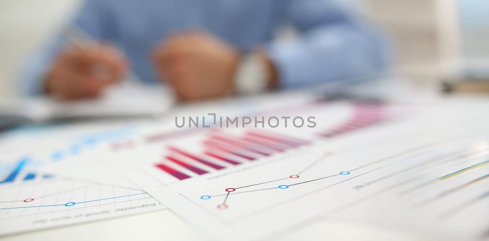 Close-up of agreement form, annual report in finance, mess with papers on desk. Business, economy, finance, accounting, chaos, deadline, project concept