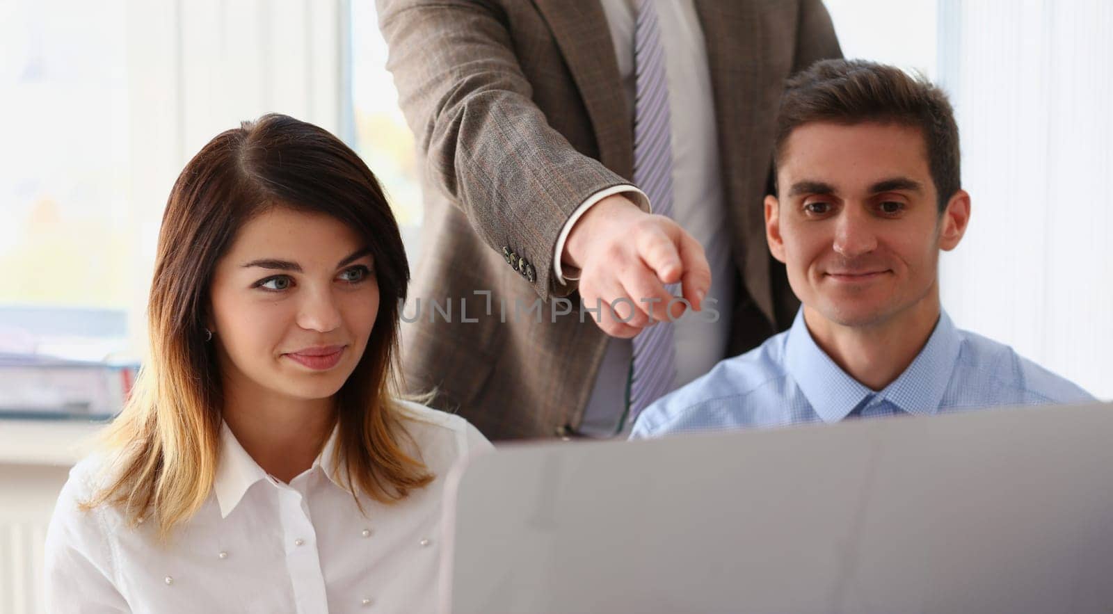 Portrait of team work on desktop computer, boss point on screen, this one, perfect choice. Idea for creative project, startup. Business, success concept