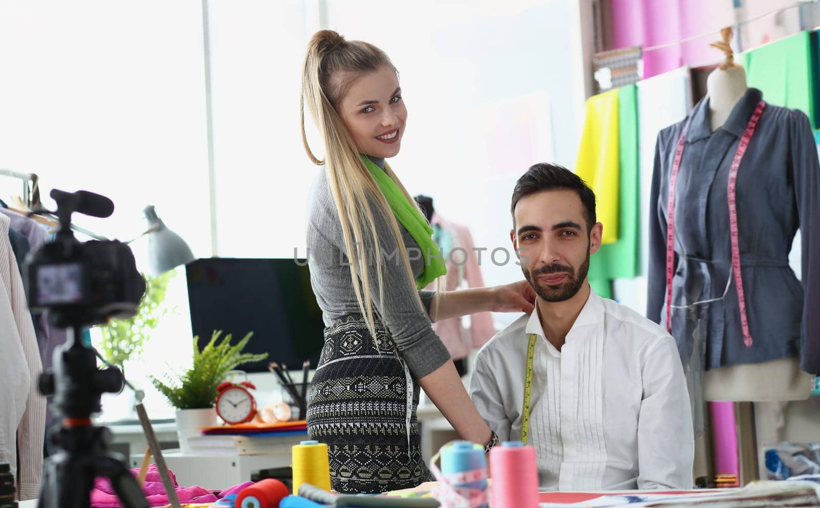 Portrait of partners tell about tailor business on camera, content for followers, dressmaker teach people how sew clothes. Blogger, creativity, art concept