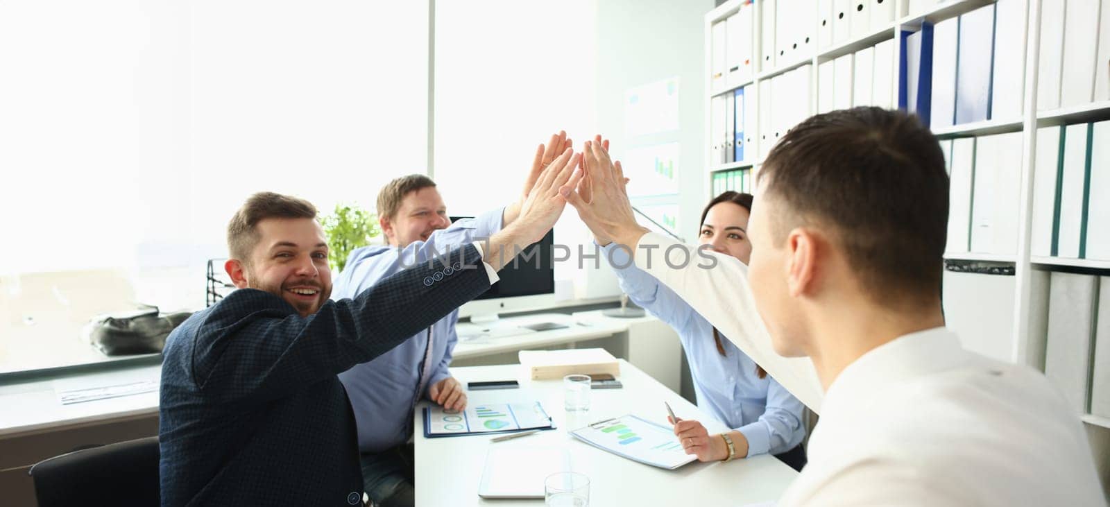 Portrait of colleagues give high five in order to celebrate successful contract, good news. Goal, success, career, new level, achievement, growth concept