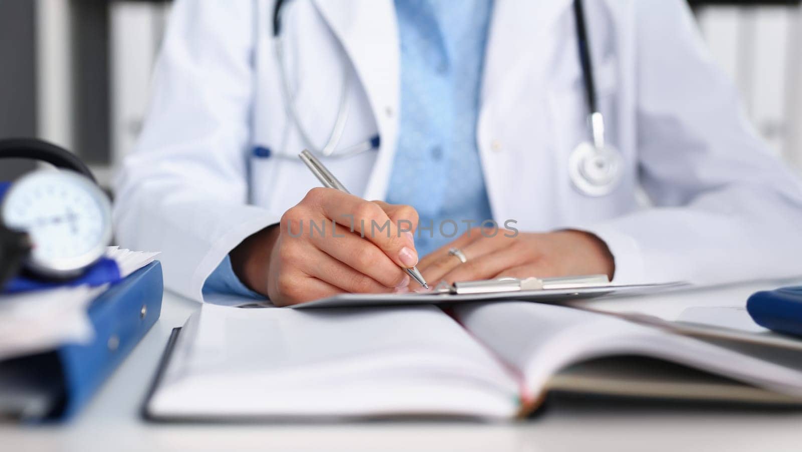 Close-up of doctor fill report or prescribe medication for ill patient, busy head doctor. Qualified medical worker in clinic. Health, consultation concept