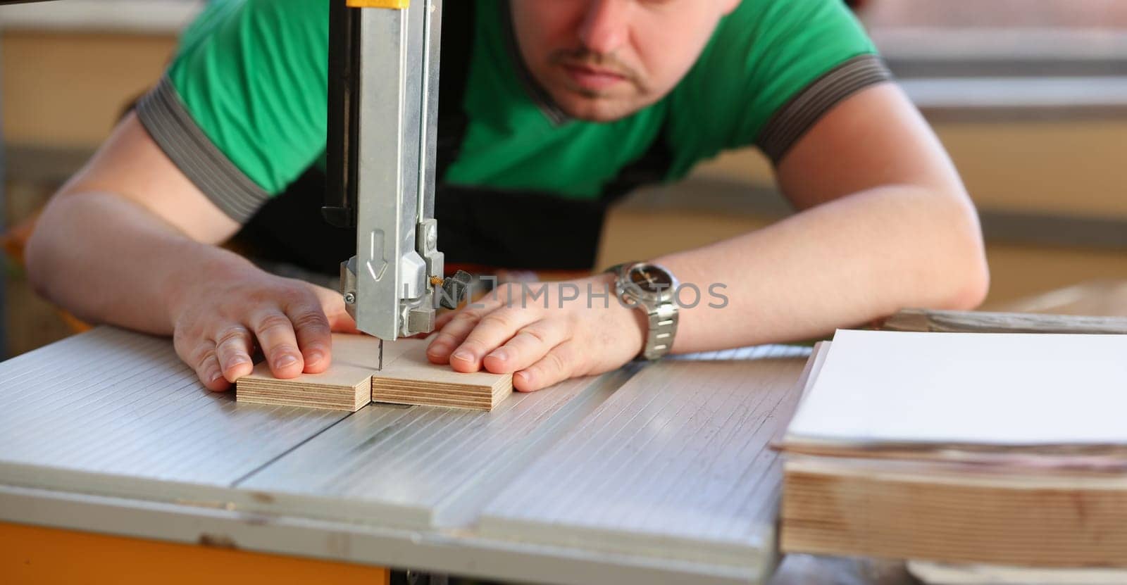Portrait of worker using electric saw, handyman on workplace, diy. Improvement, startup idea, industrial building. Carpentry, renovation, design concept