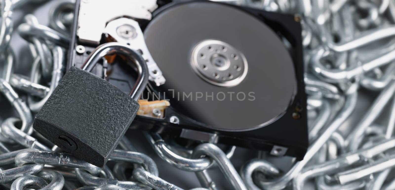 Close-up of data on cd rom secured with chain and padlock equipment, key hole. Keep safe your personal information. Security, protection, safety concept