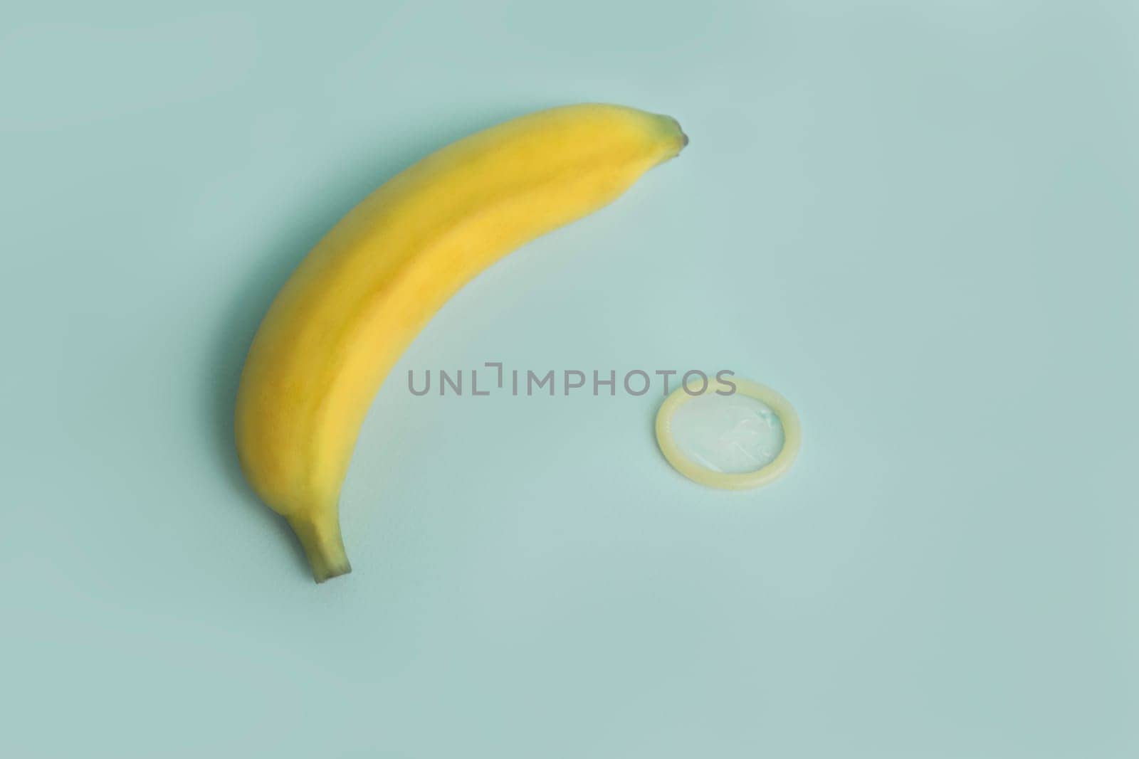 Sex education and safe sex. Banana and condom concept of the penis in contraception.