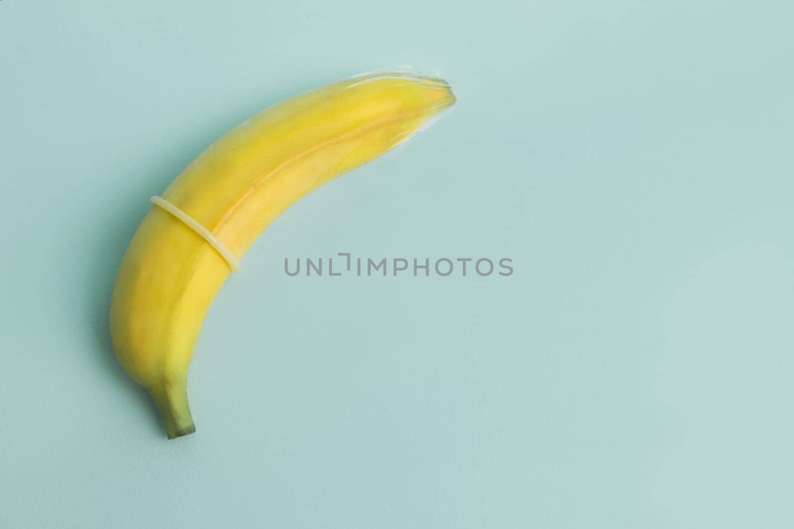Sex education and safe sex. Banana and condom concept of the penis in contraception.