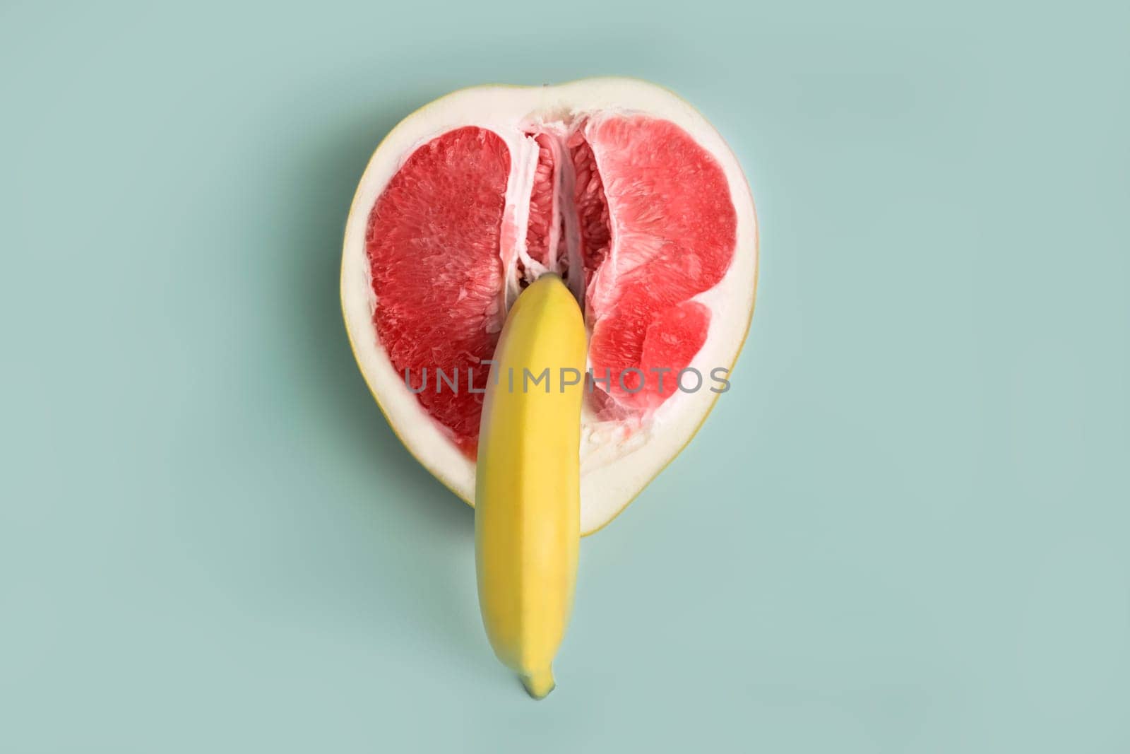 Banana and grapefruit flat lay minimal composition . A metaphor of sex, sexuality, vagina and penis.