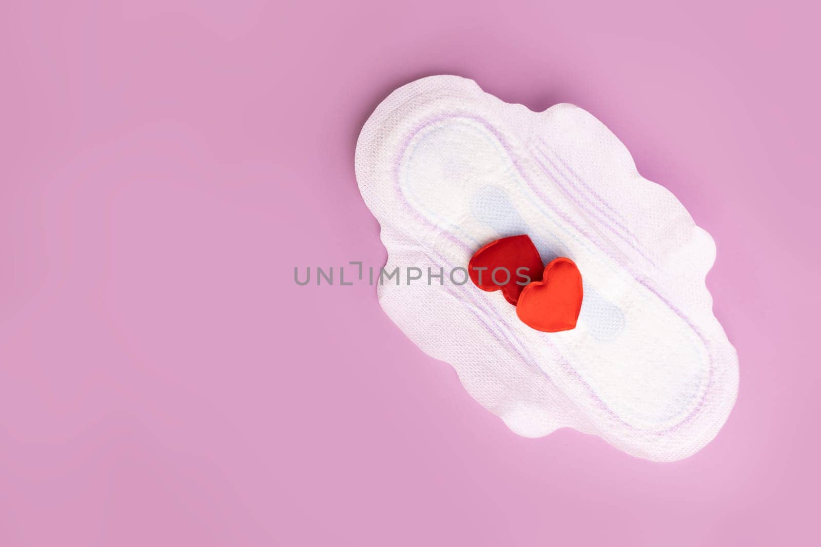Menstruation and critical days. Gasket for menstruation on which there are two hearts in the form of blood drops.