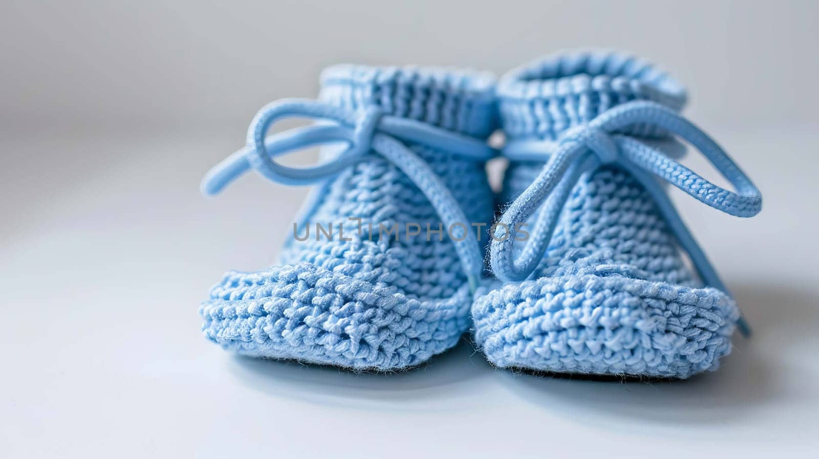 baby booties on a white background. Selective focus. Generative AI,