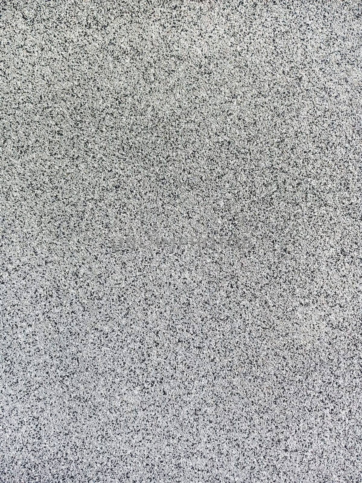 close-up texture shot of a rough, grey surface reminiscent of concrete or stucco. The granular quality and uneven shade variation make it suitable for backgrounds, graphic design, or 3D modeling references.