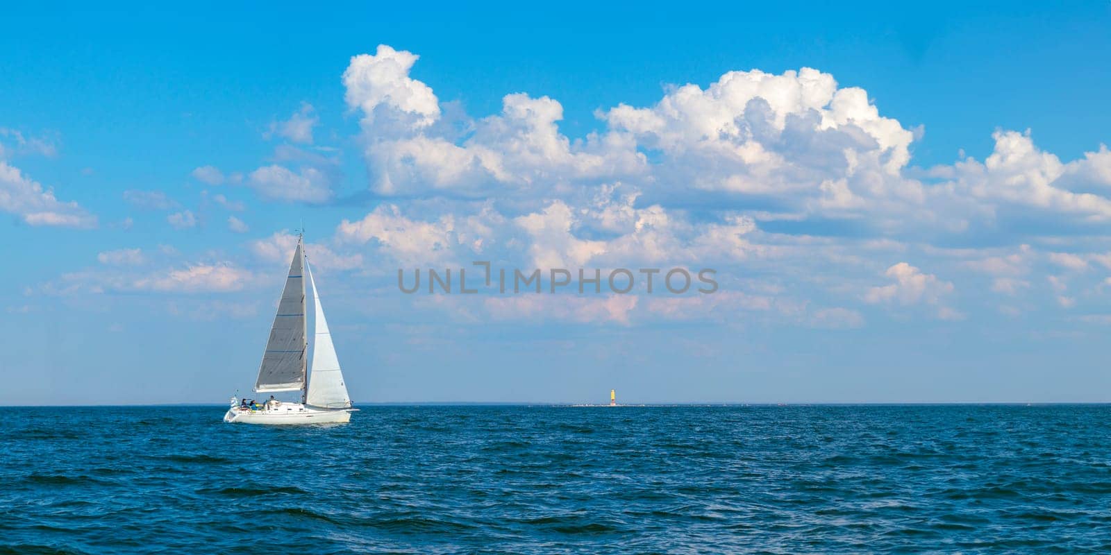 Yacht, white sailboat under head genoa and main sails sailing in an calm open sea. Cruise, vacations, regatta, sport. Gulf of Finland