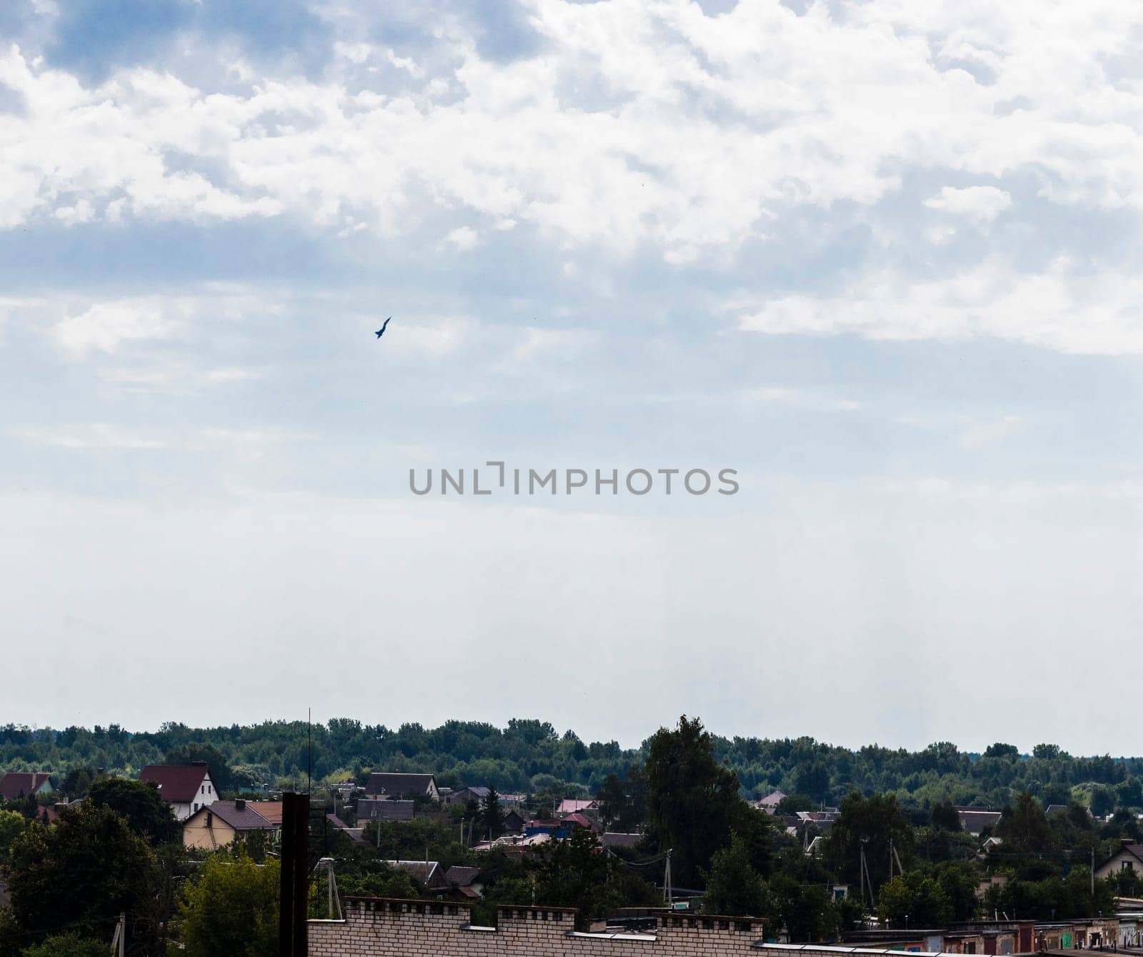 Silhouette of the MIG fighter jet in the cloudy sky