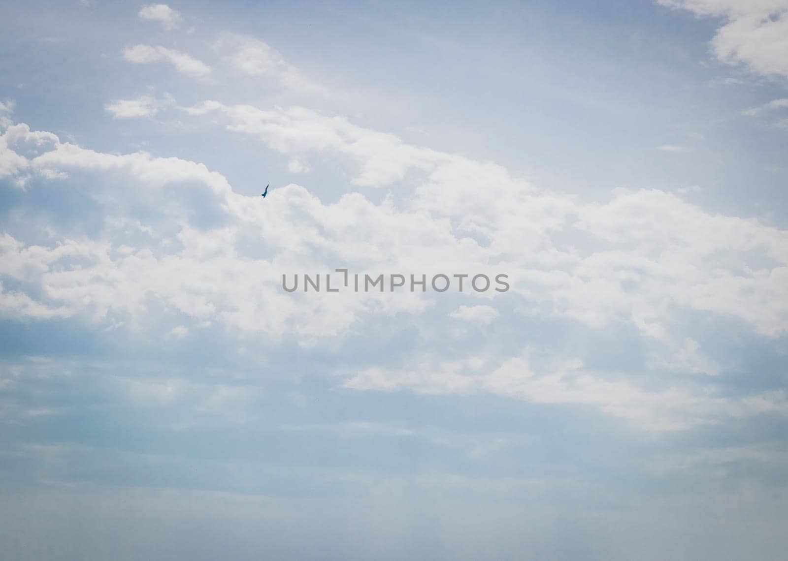 Silhouette of the MIG fighter jet in the cloudy sky