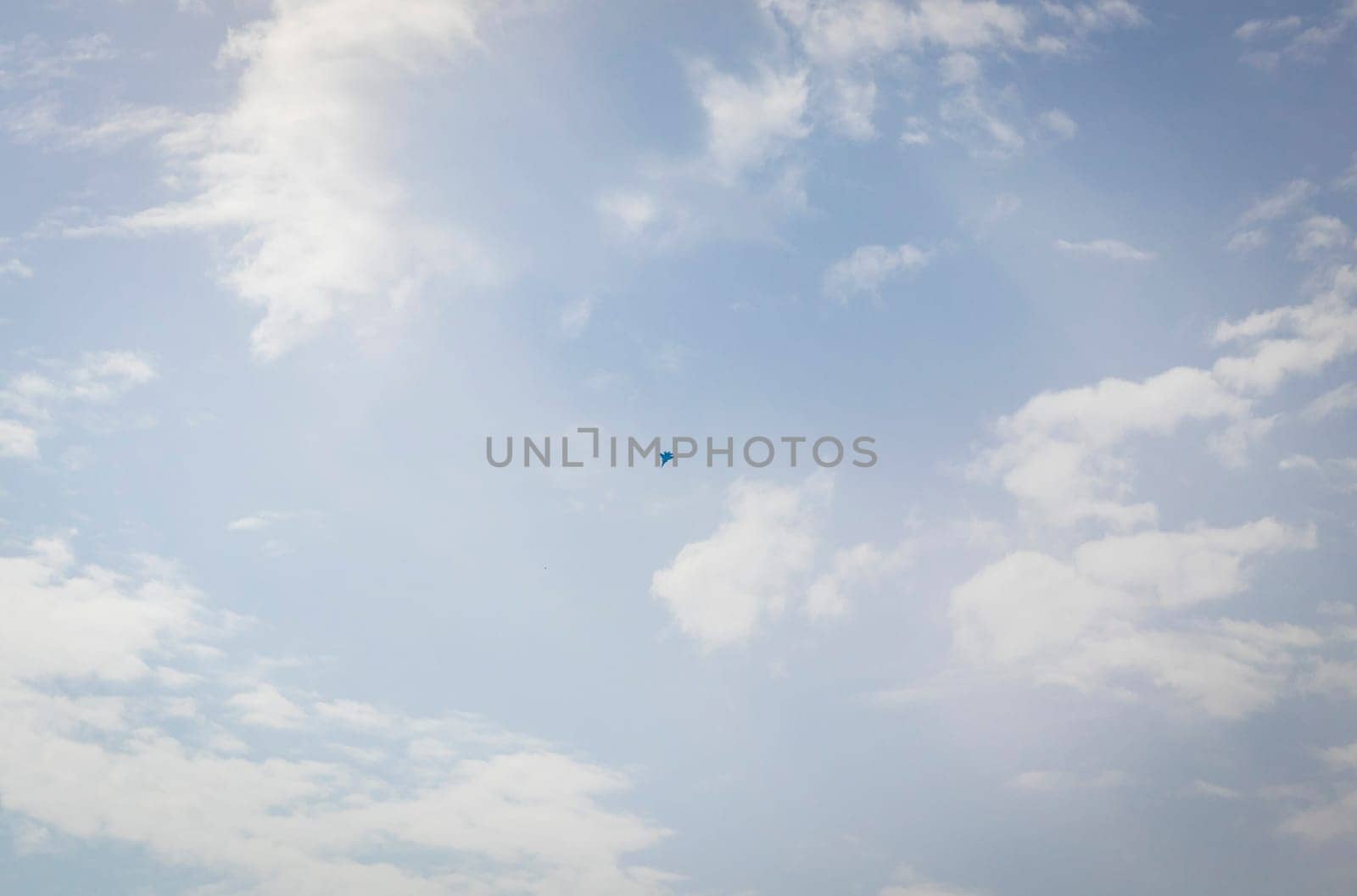 Silhouette of the MIG fighter jet in the cloudy sky