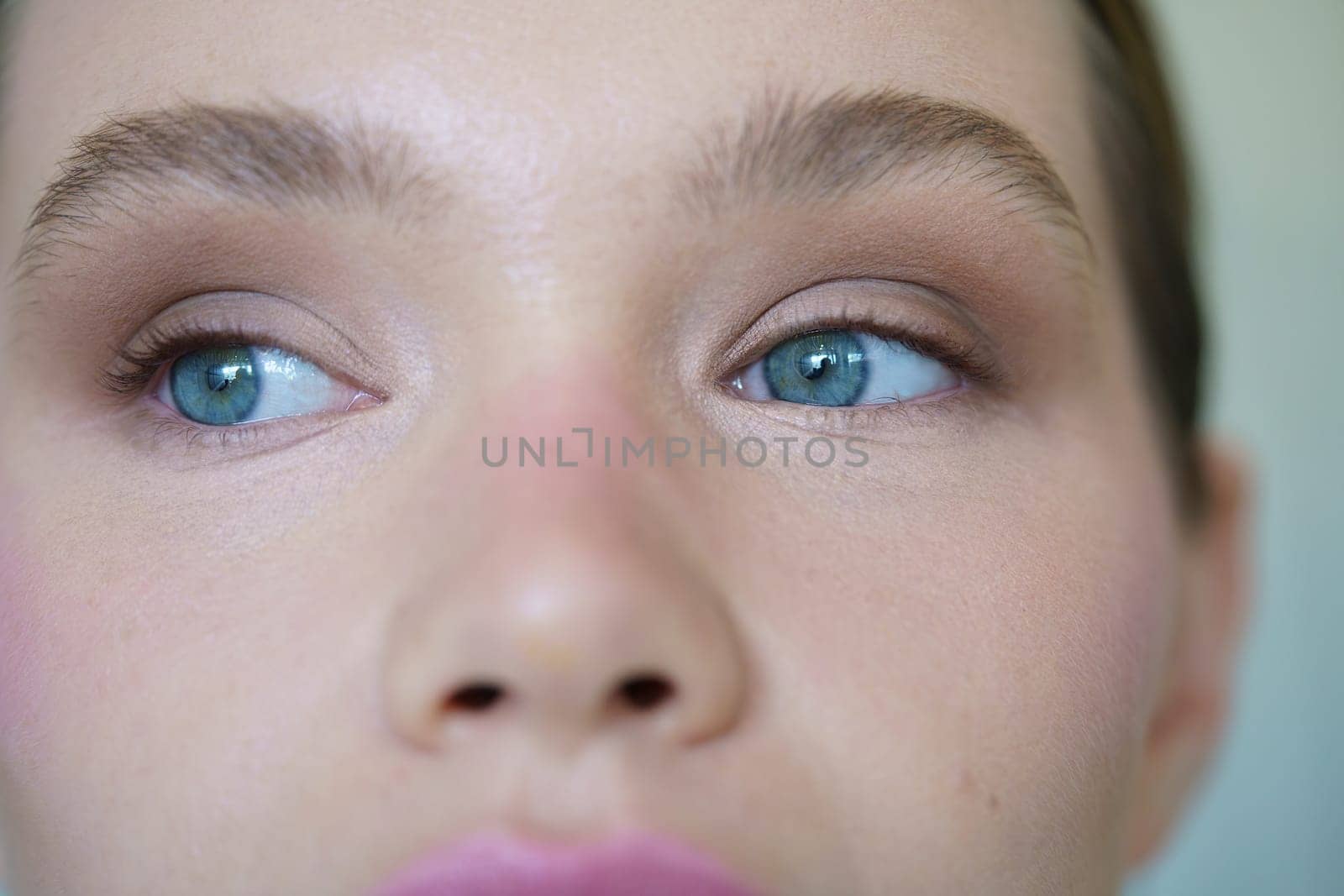 Close-up of a caucasian woman with blue eyes indoors