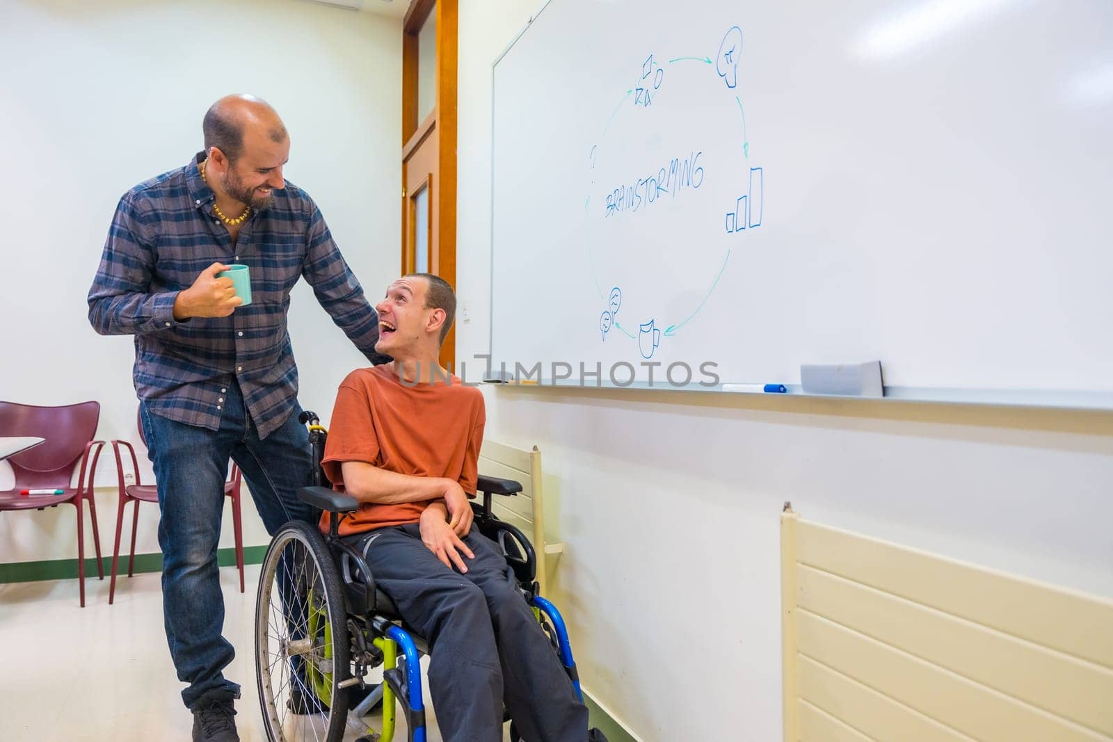 Brainstorming meeting of a man with disability and a colleague in the university