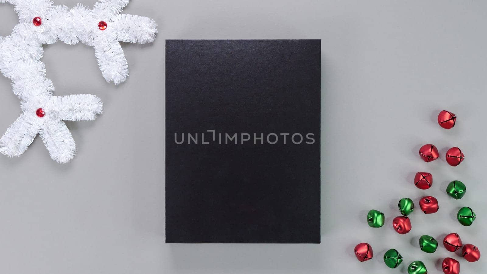 Template composition with blank black box, gift box, product packaging on grey background with holiday decore. Mockup, photo card, Christmas card, greeting card by JuliaDorian