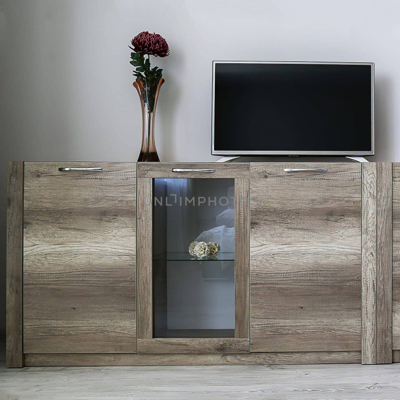 A light brown cabinet with transparent glass, there is a TV on it, a vase with a red flower, front view. Minimalism concept.