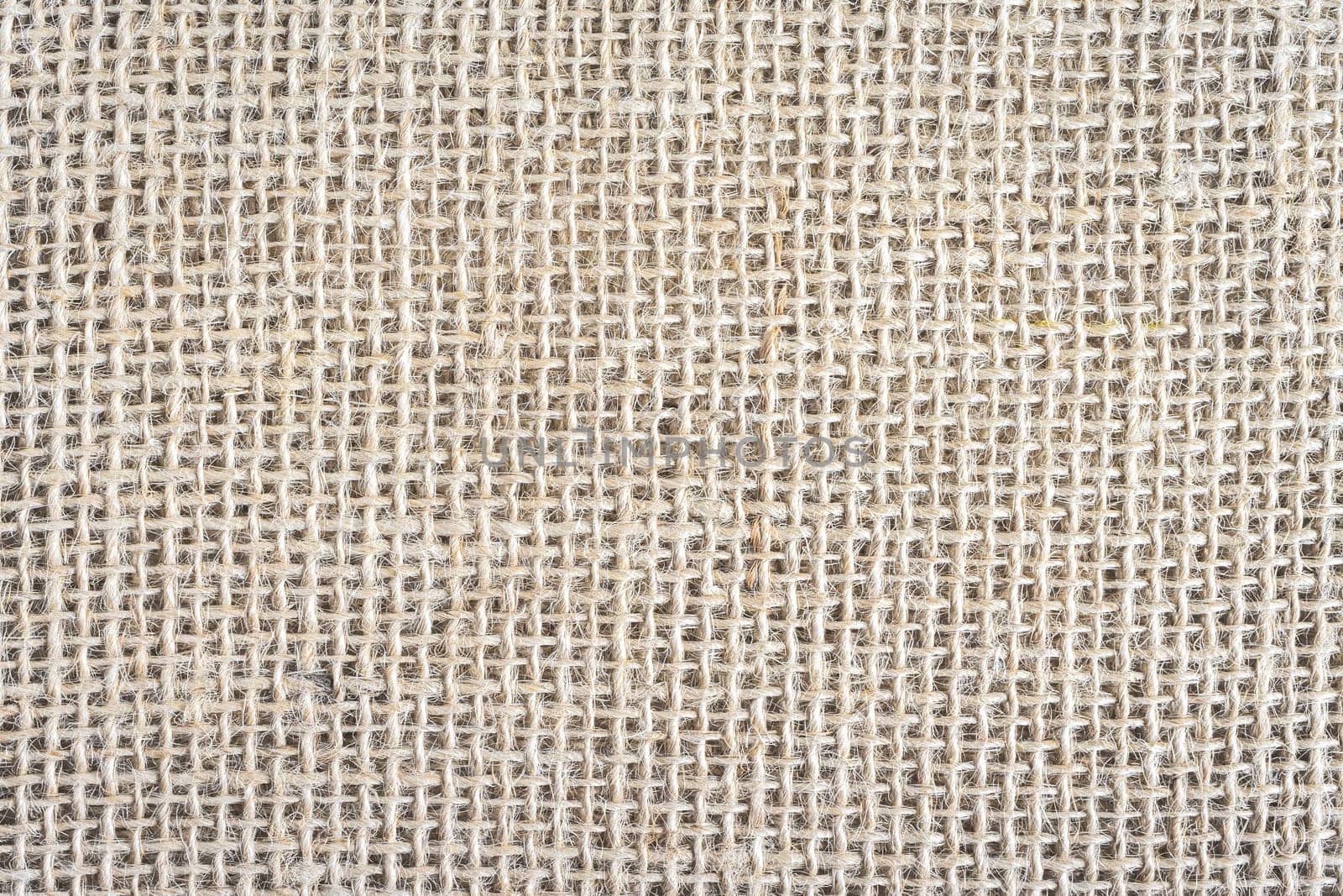 Abstract background, close up photo from a piece of Burlap fabric.