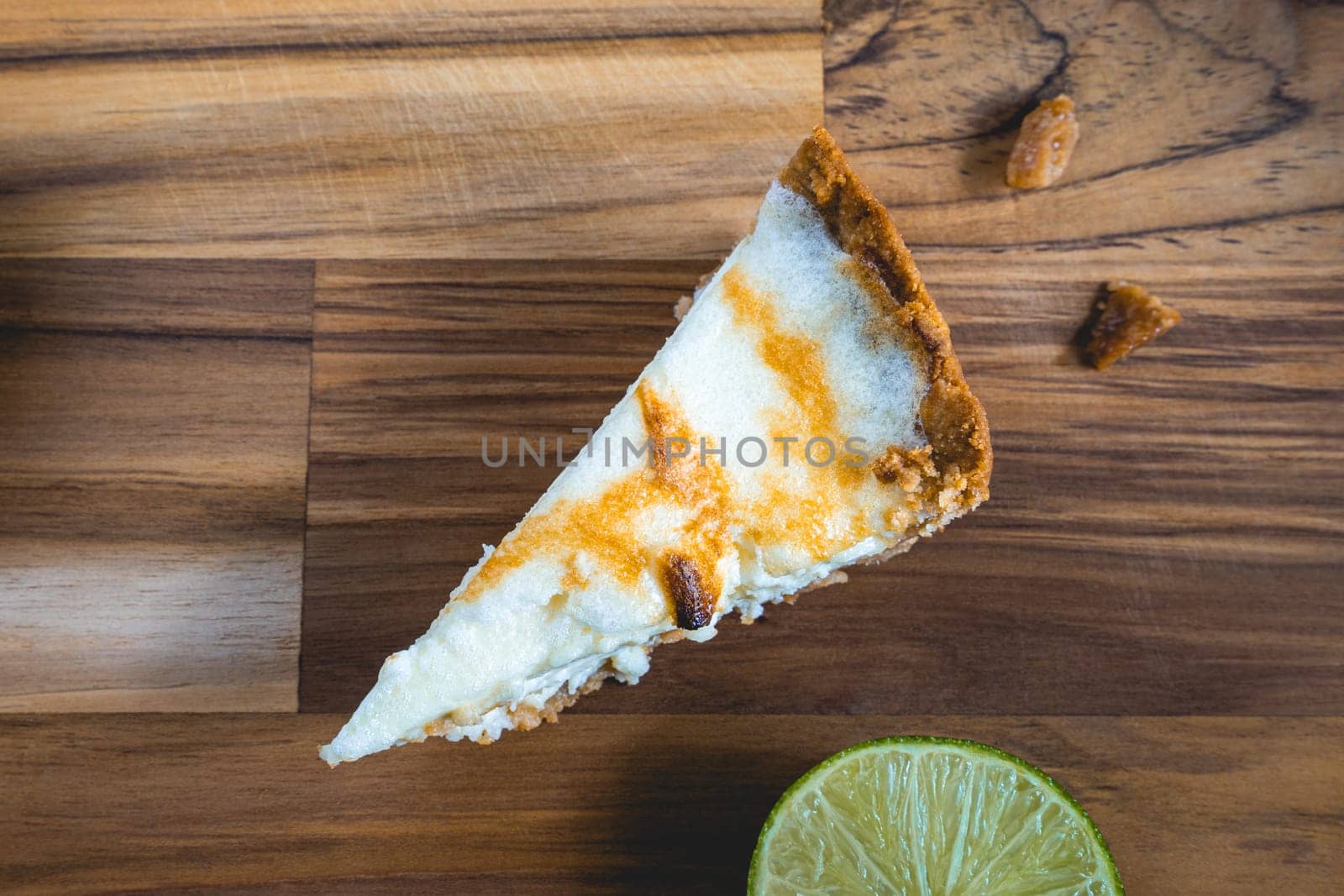 A home made Lemon pie, on a wooden plate. Decorated with lemons.