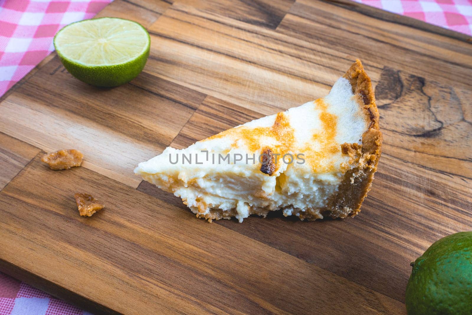 A home made Lemon pie, on a wooden plate. Decorated with lemons.