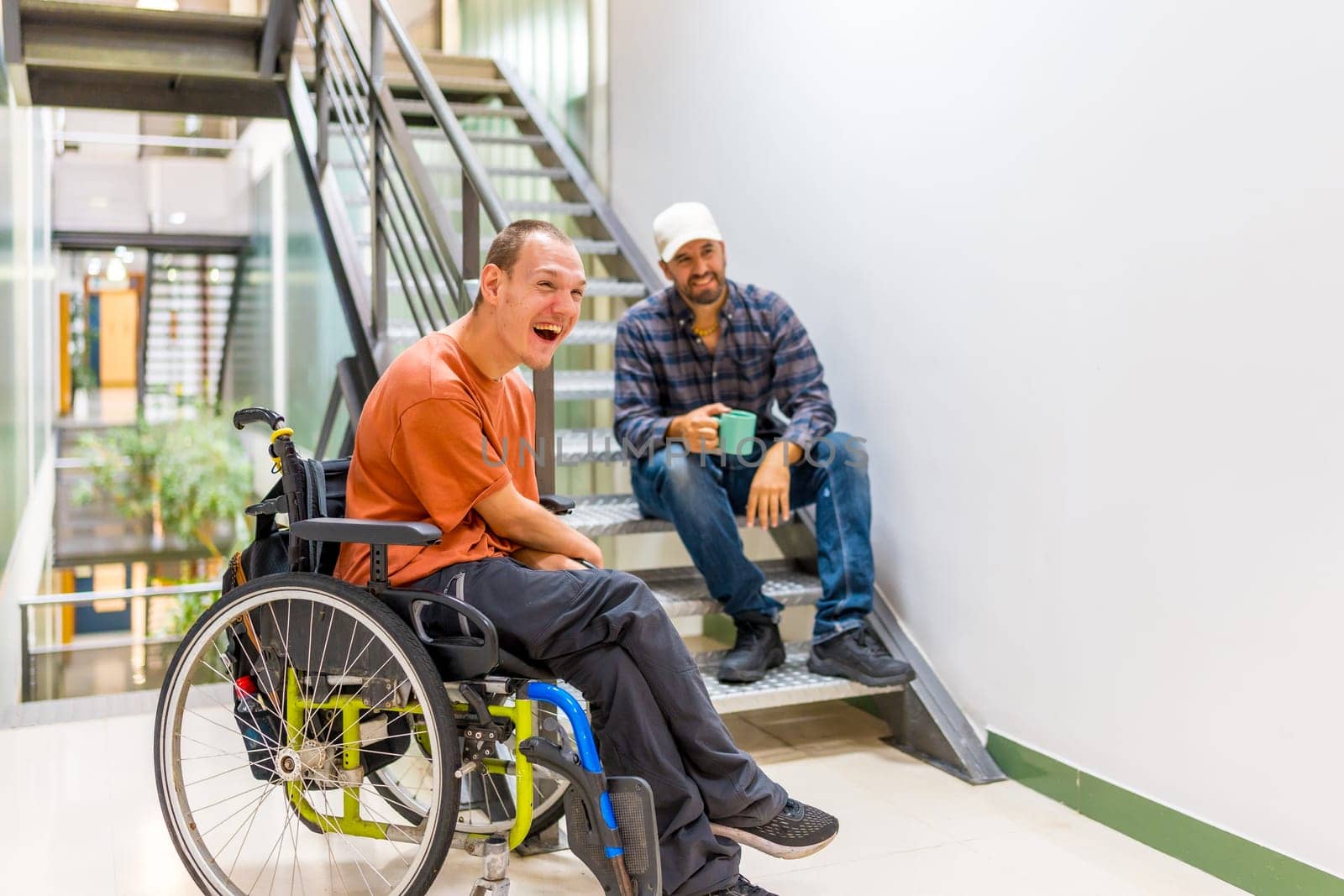 Happy work mates with disability having fun in a work break