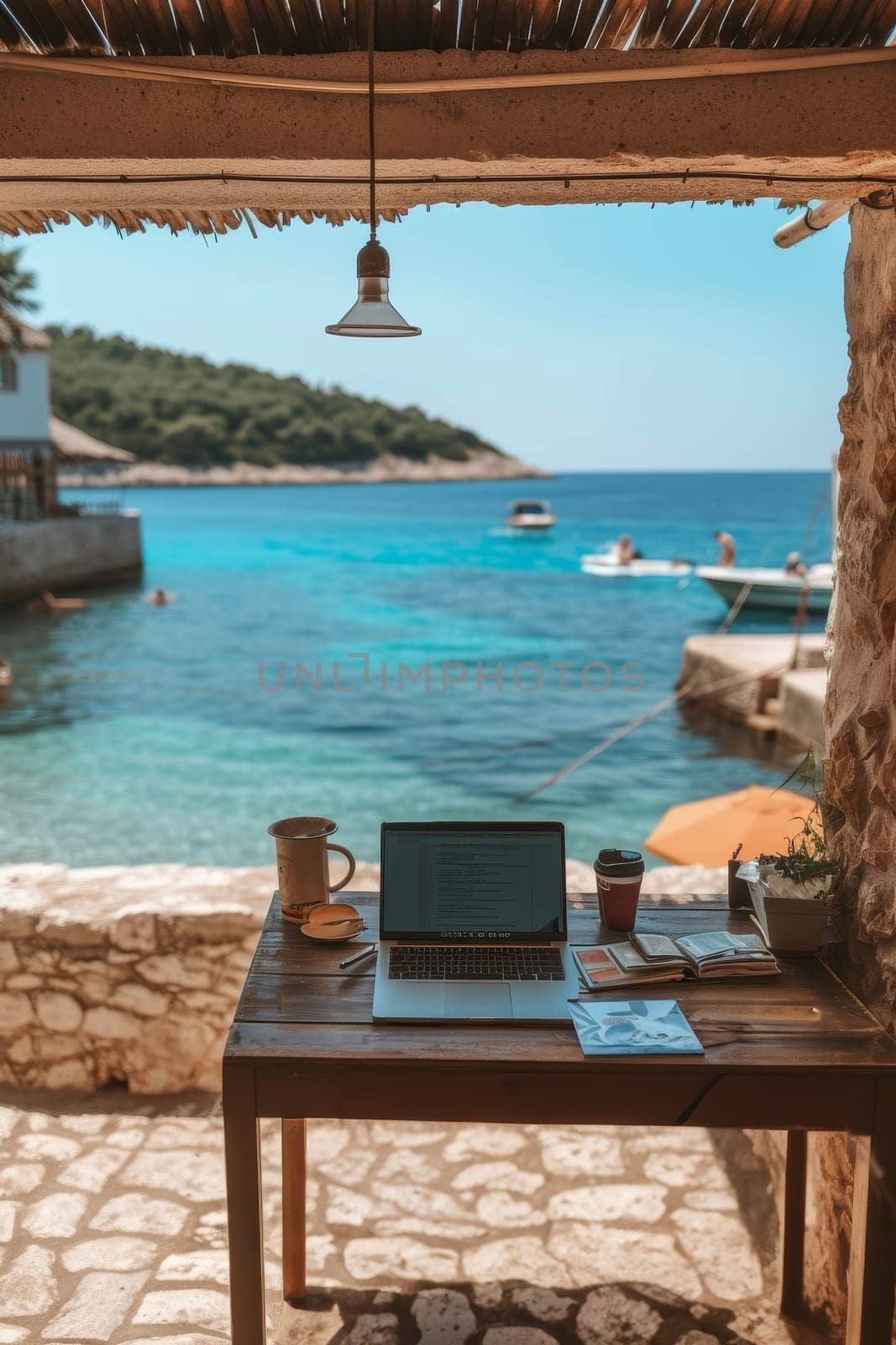 Laptop on a wooden table with a scenic sea view, perfect for remote work or a relaxing study session