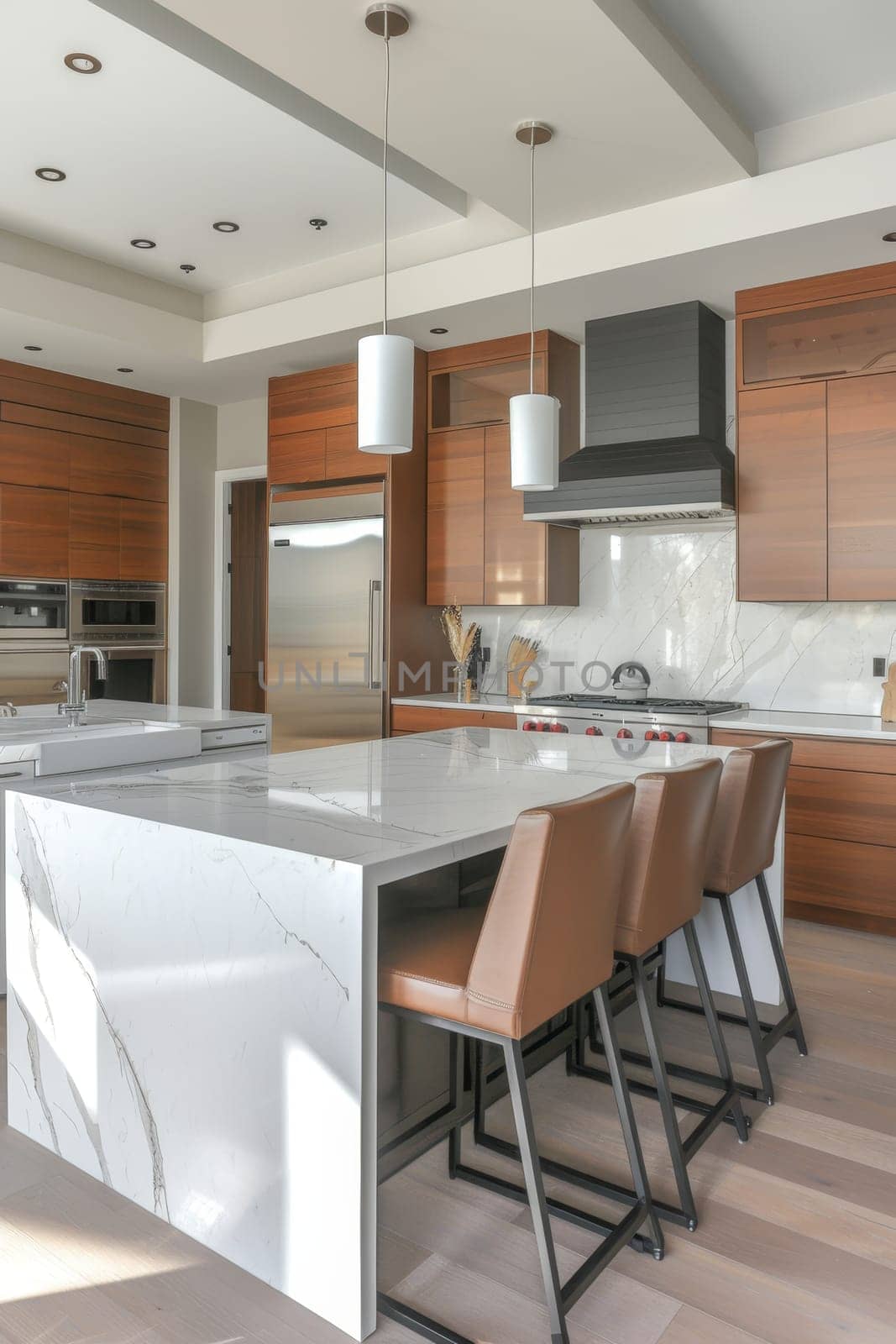 Modern kitchen with warm wood cabinets and a large white island in a bright interior space
