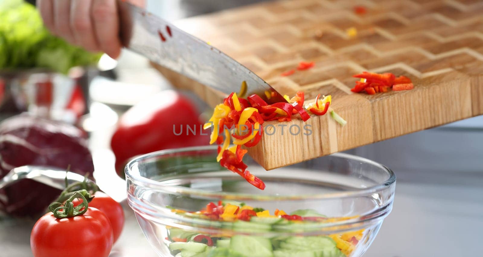 Colorful Yellow Chopped Chili Pepper Pouring Bowl. Man Cooking Dieting Vegetable Salad. Red Tomato and Slices of Cucumber in Bowl. Dieting Culinary Recipe. Delicious Vegan Dish Horizontal Photo