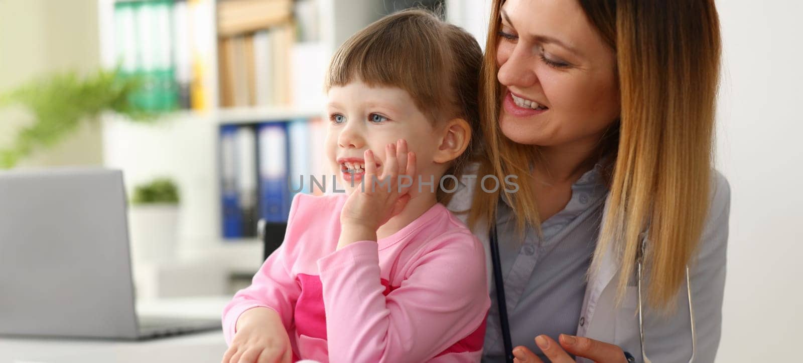 Cute little girl visiting family doctor office portrait