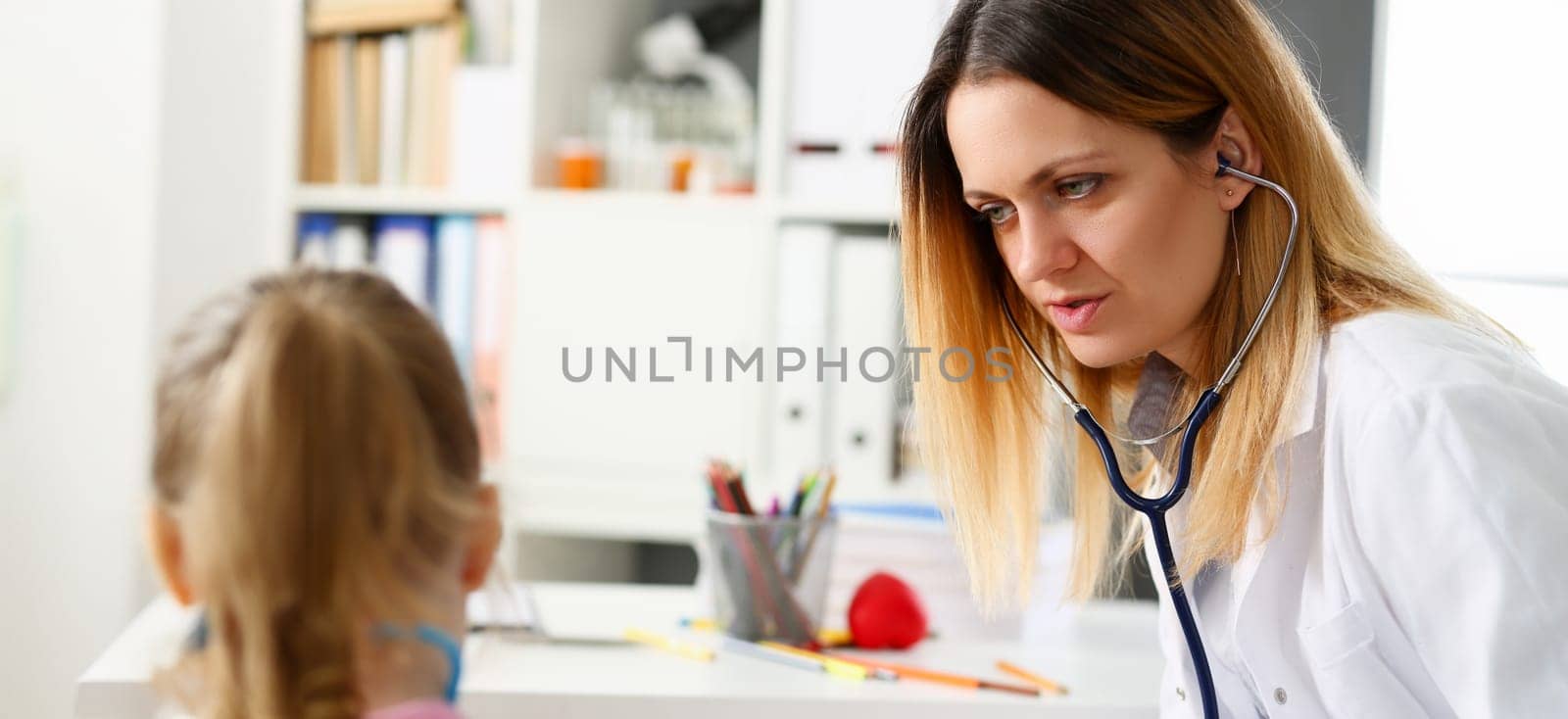 Child doctor with stethoscope communicate with little patient listening for heart beat
