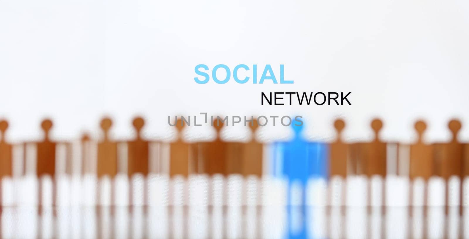 Social network sign above line of toy human figures concept