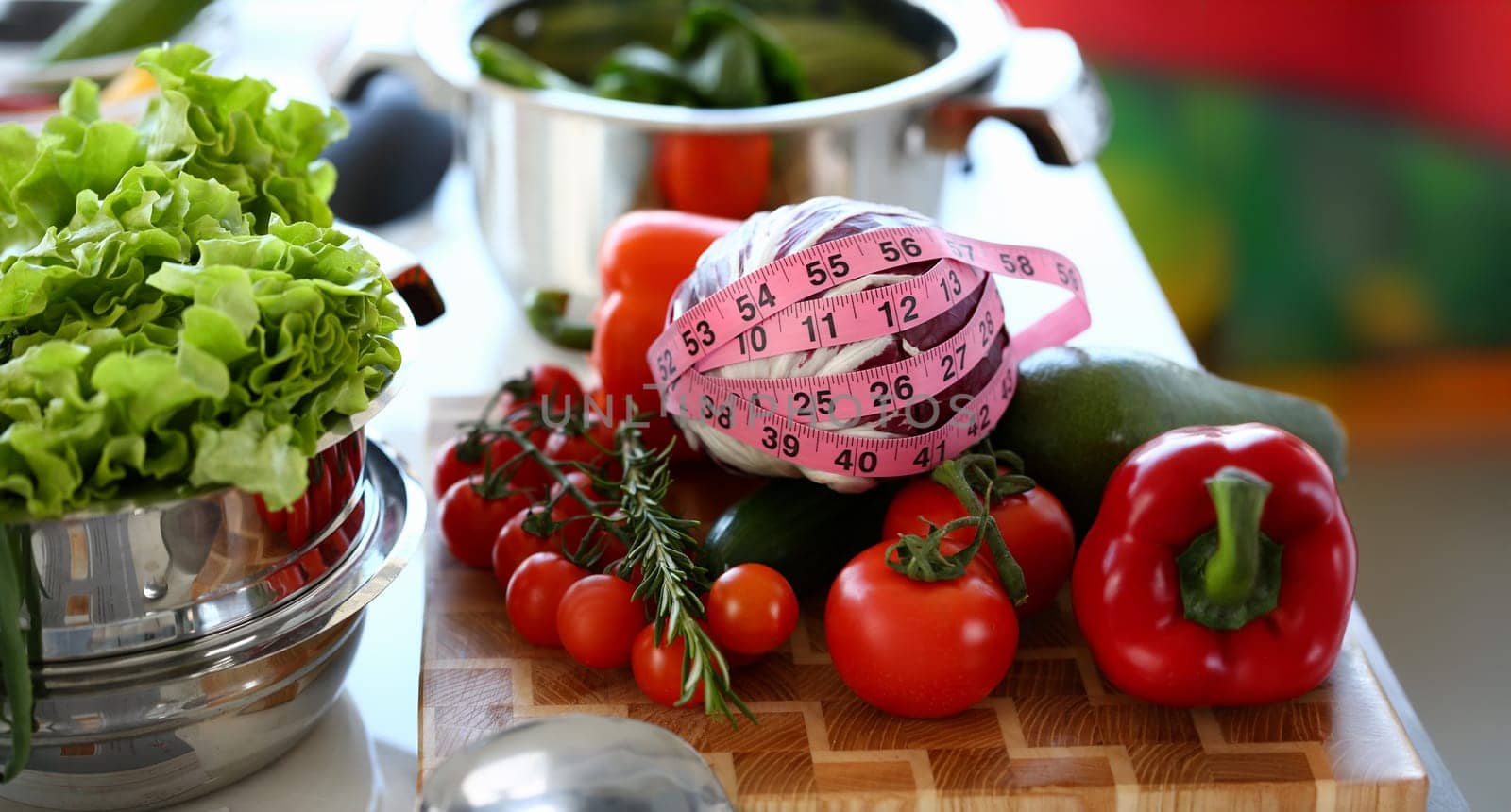 Healthy Fresh Vegetables Assortment Measuring. Organic Red Cherry Tomato, Ripe Pepper, and Cabbage Wrapped in Centimeter on Kitchen Worktop. Green Lettuce in Saucepan. Horizontal Photography