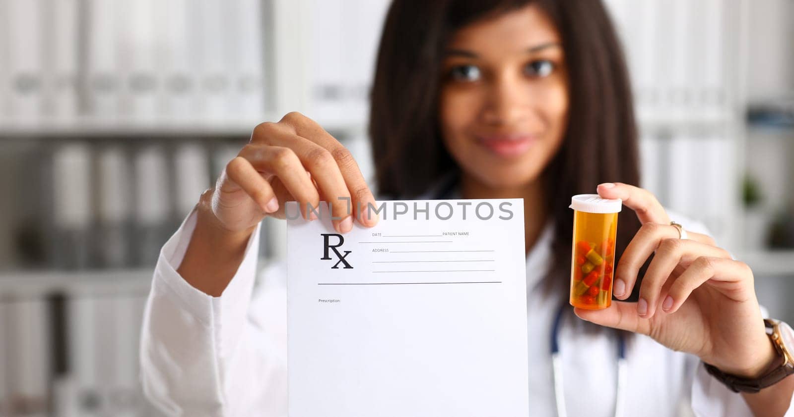 Female black doctor hands hold and give to visitor prescription and jar of pills closeup. Panacea life save healthy lifestyle prescribe treatment legal drug store contraception concept