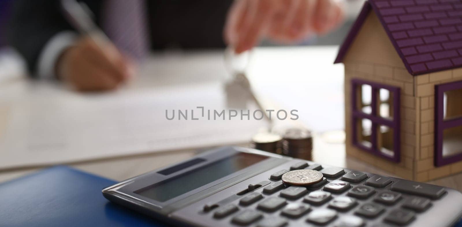 Home Keychain in Real Estate Agent Hand House Rent. Property Loan Sale Concept. House, Calculator. Bank Credit for Residential Purchase. Appertment Sell Items. Mortgage Safety Background
