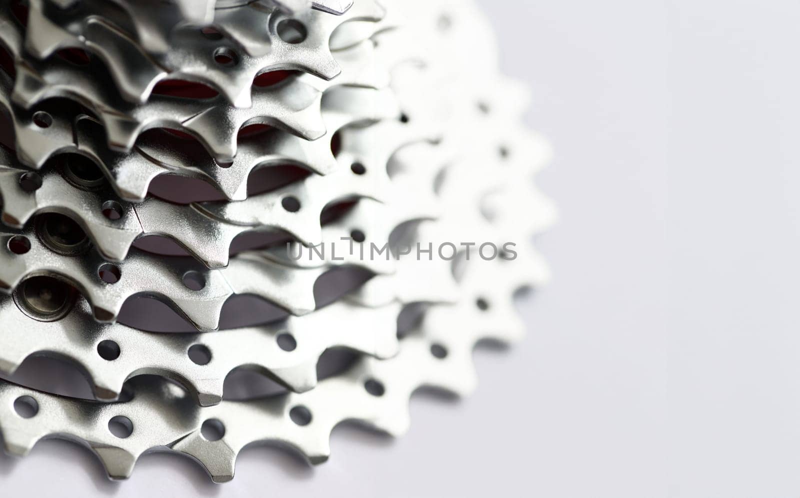 Close-up of posterior derailleur of modern mountain push-bike. Bicycle detailed view on wheel with chain and sprocket disc brake. Push-bicycle workshop concept
