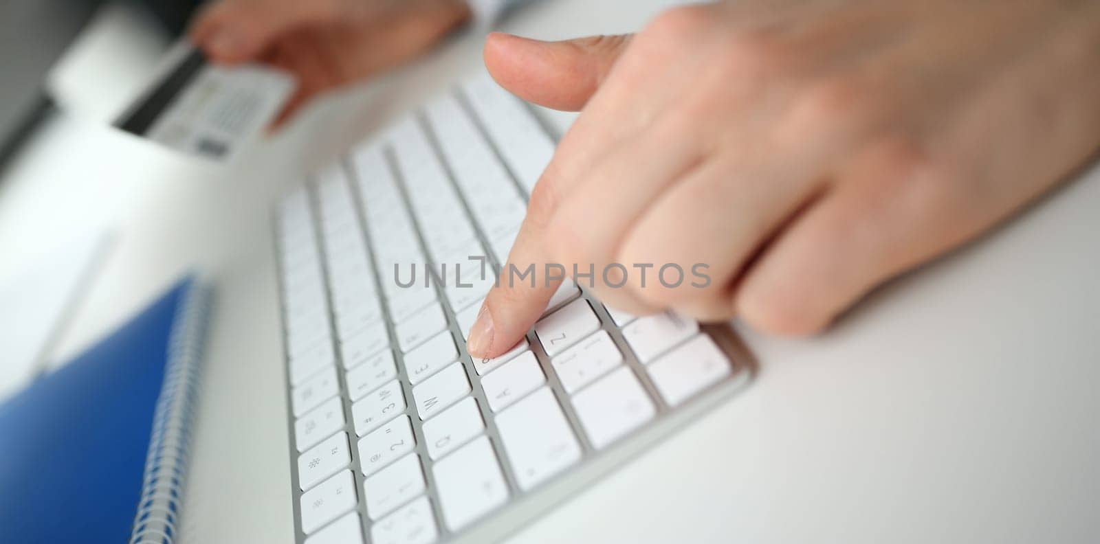 Female arms hold credit card press buttons making transfer closeup. Anti-fraud financial security when entering client discount program number or filling personal credential password login to account