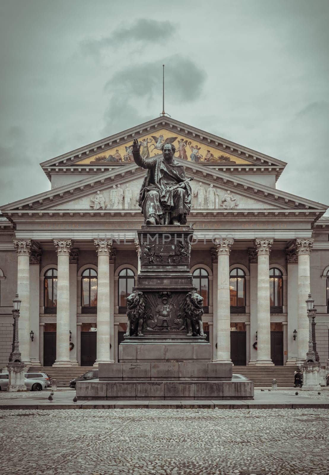 Munich, Germany - Dec 21, 2023 - Monument Bronze Statue of King Maximilian I Joseph of Bavaria in front of The National Theatre of Munich (Nationaltheater) or Bavarian State Opera (Residenztheater) at the Max Joseph Square in central Munich. Space for text, Selective focus.