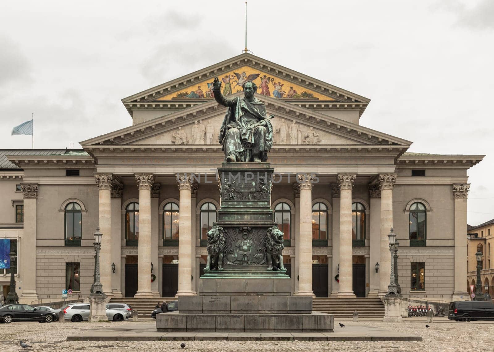 Munich, Germany - Dec 21, 2023 - Monument Bronze Statue of King Maximilian I Joseph of Bavaria in front of The National Theatre of Munich (Nationaltheater) or Bavarian State Opera (Residenztheater) at the Max Joseph Square in central Munich. Copy space, Selective focus.