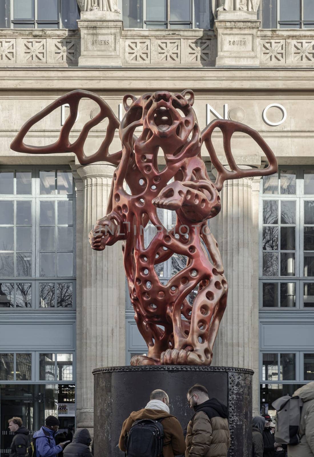 France, Paris - Jan 05, 2024 - View of the Angel Bear red sculpture made (A piece of contemporary art) by the artist Richard Texier in front of the main Gare du Nord or Paris train station.