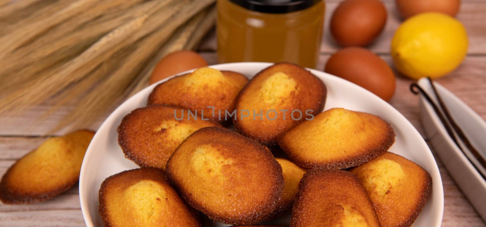 Delicious madeleine cake on white background flavoured with honey, lemon and vanilla, High quality photo