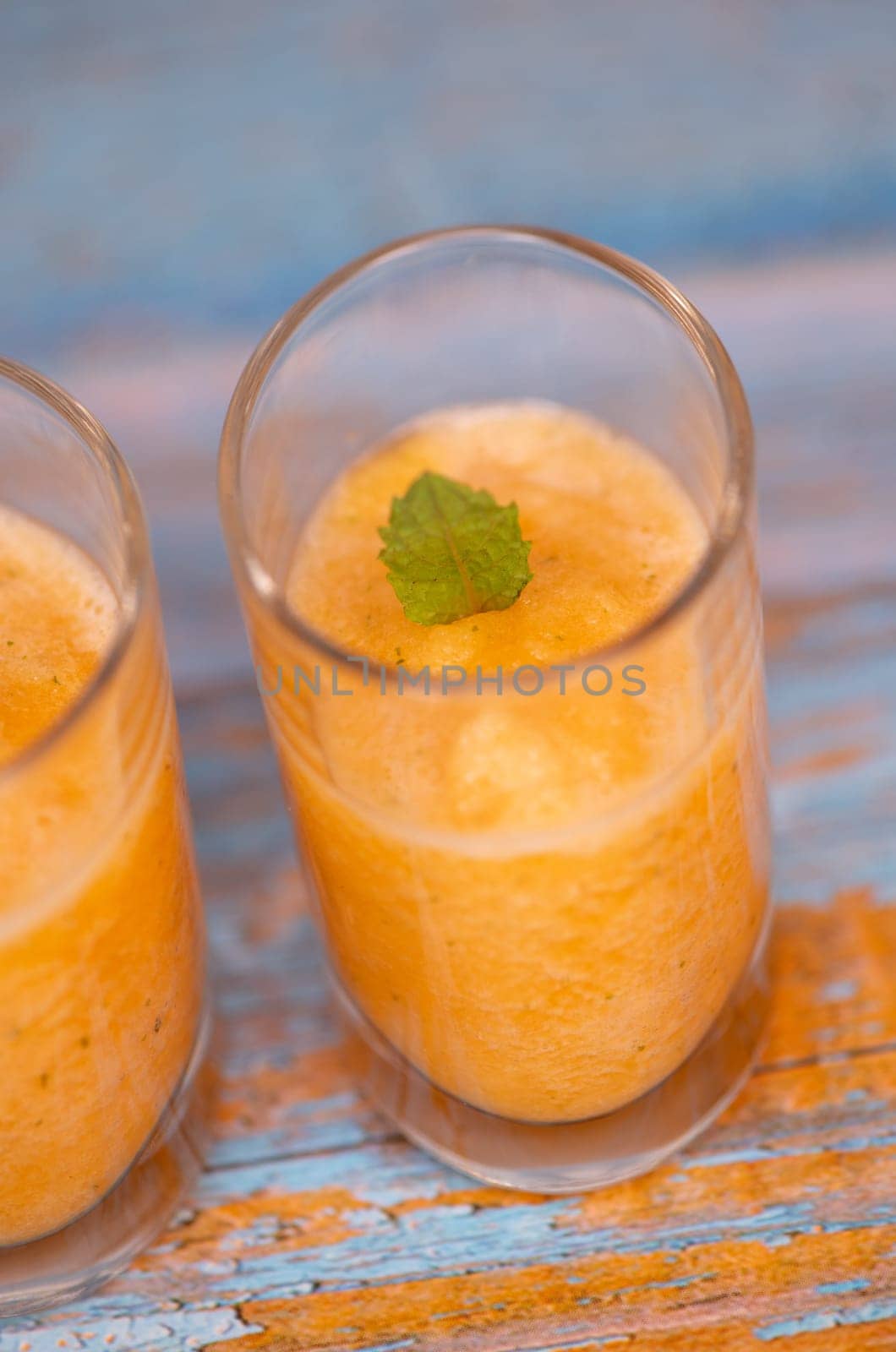 Bowl of tasty melon sorbet, melon and mint leaf verrine, High quality photo