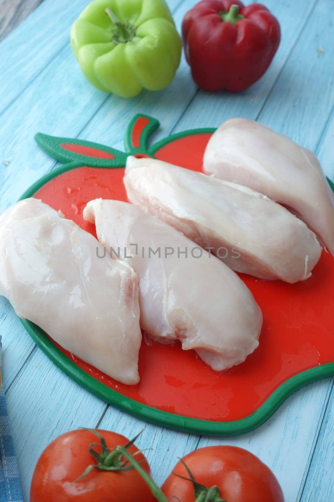 raw breast chicken meat on a plate on white background.